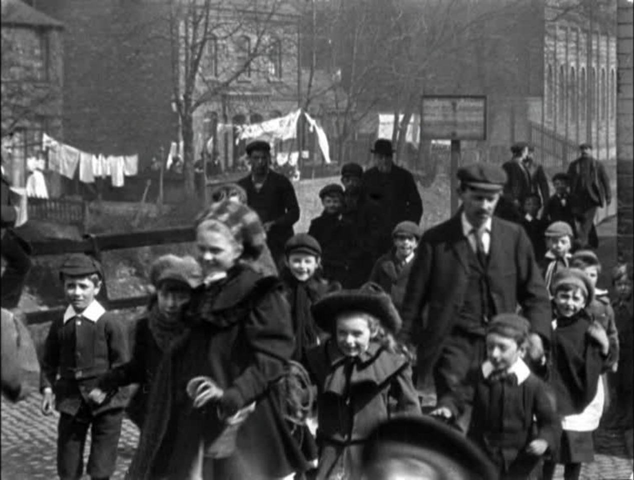 Victorian industrial workers leave their factory after a demanding day.