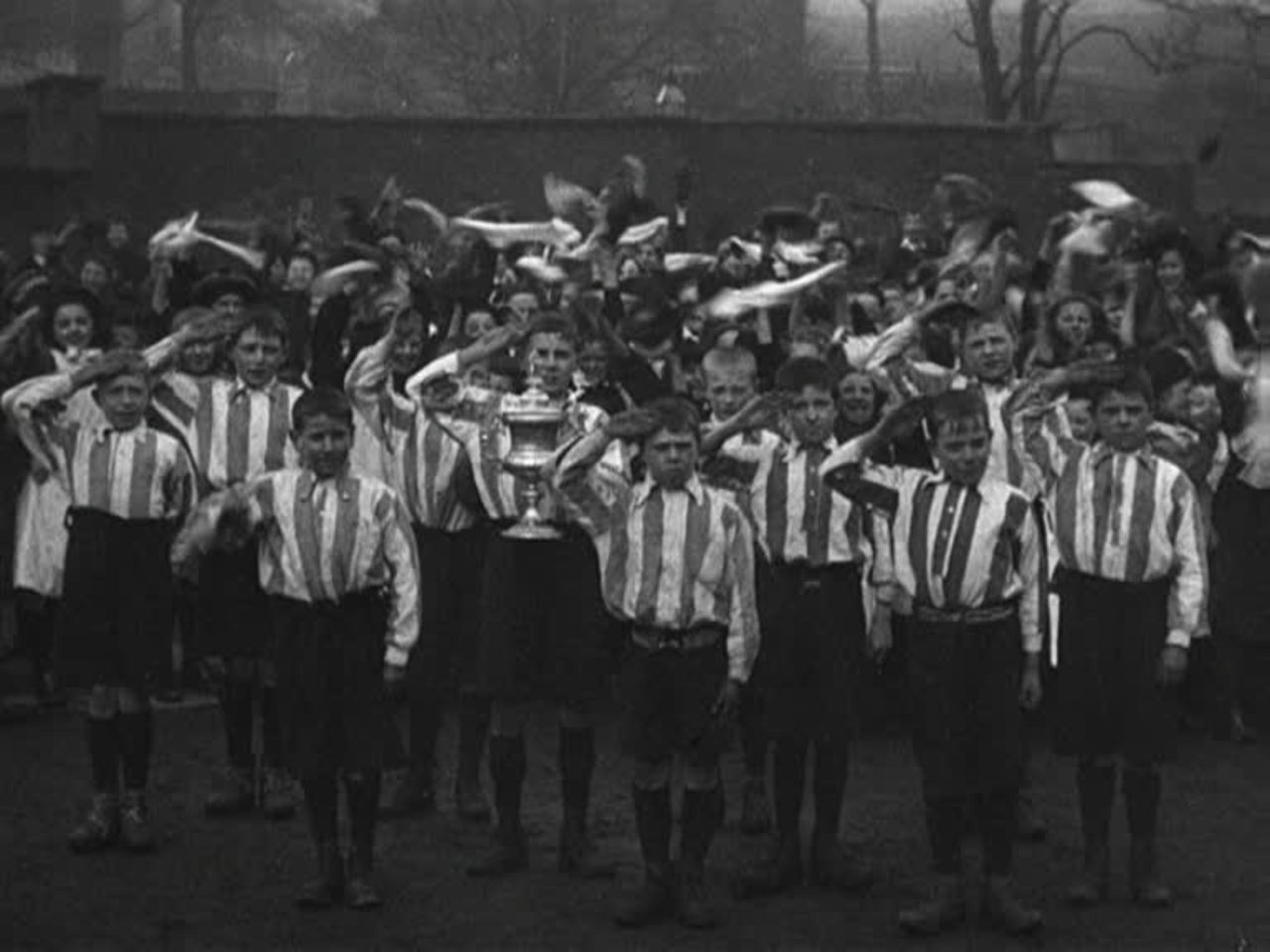 The proud winners of a Blackburn school football match pose for posterity.