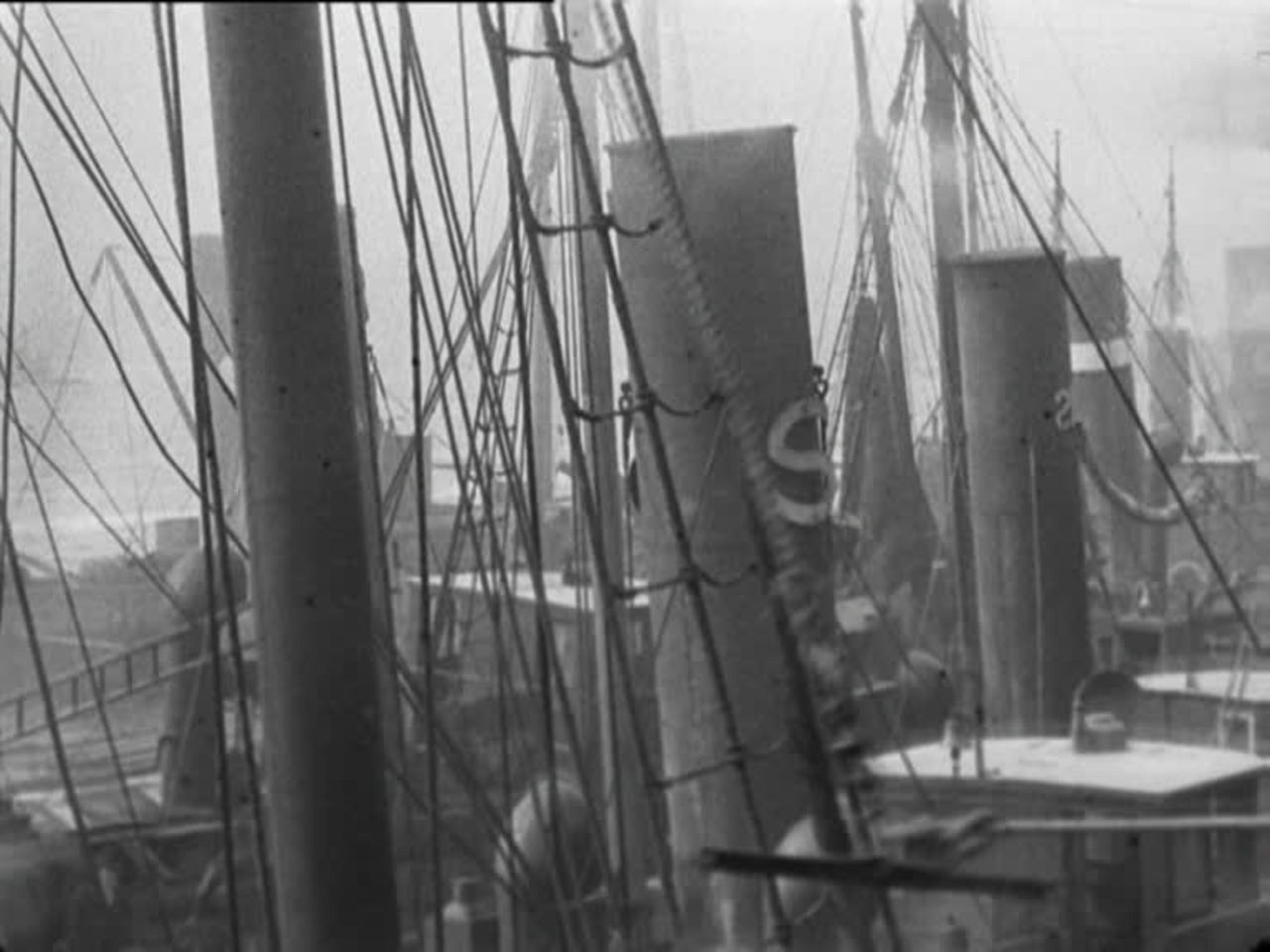Girls gut herring on the quay at North Shields while a Showman tries to stir up trouble.
