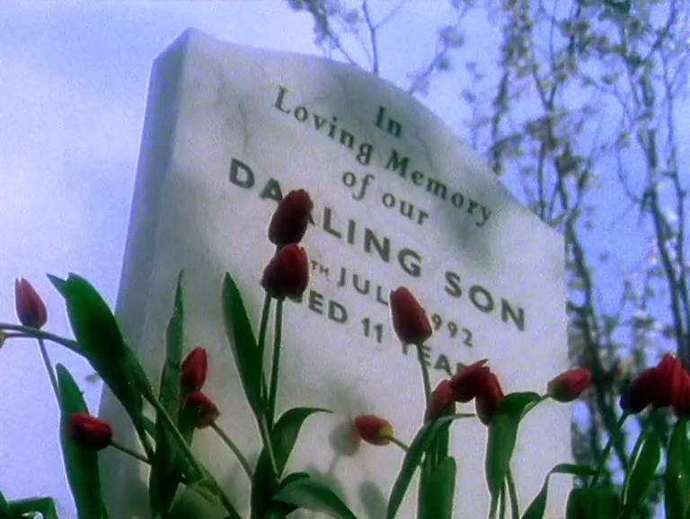 There's a quiet grave in the middle of this leafy suburban roadway.