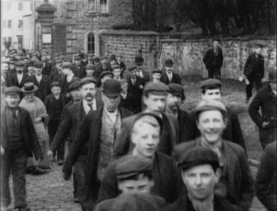 Mystery workers hurry through cobbled streets