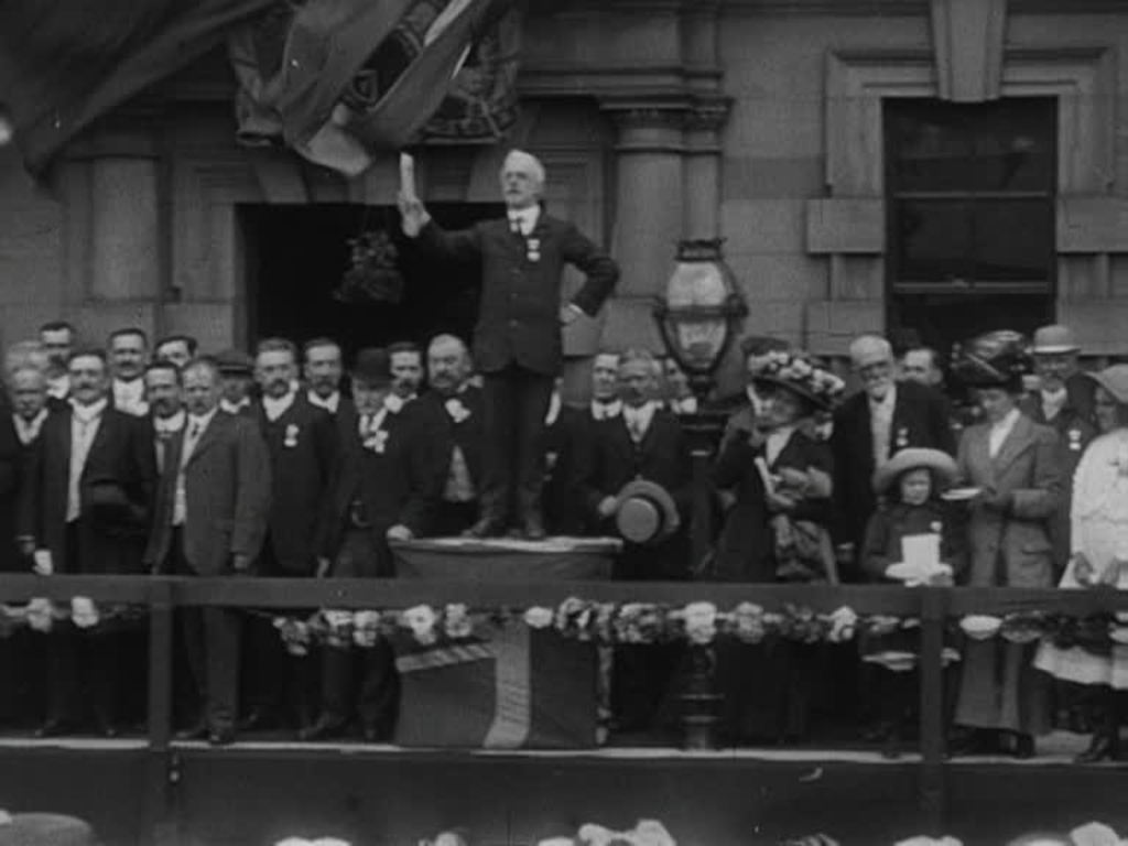 Crowds celebrate the crowning of George V and his consort Mary on a windy June day in the Lancashire mill town.