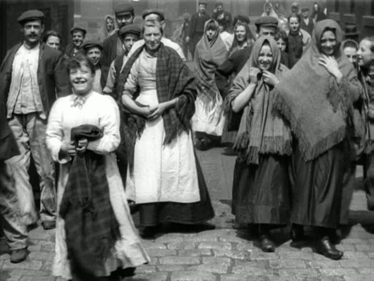 A flood of Lancashire cotton workers and their children at the end of another shift.
