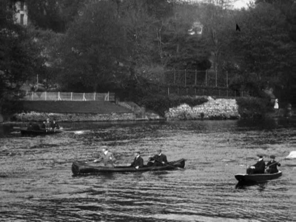 Oarsmen compete along the River Lee in early 20th century Cork.