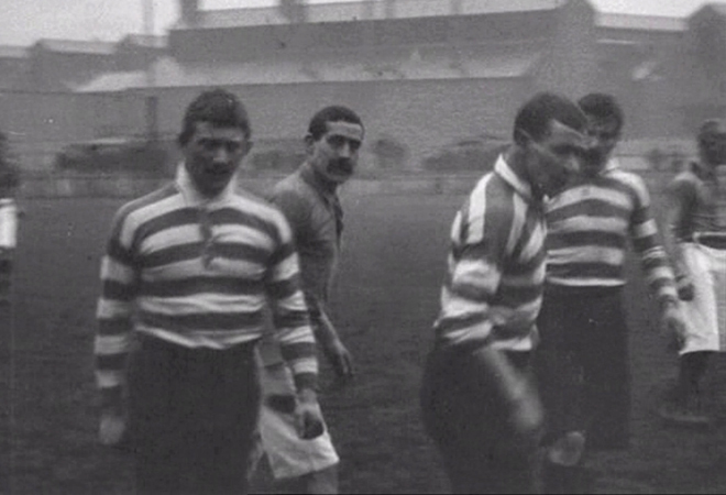 Match action and scenes of an Edwardian rugby crowd at Warrington's Wilderspool stadium.