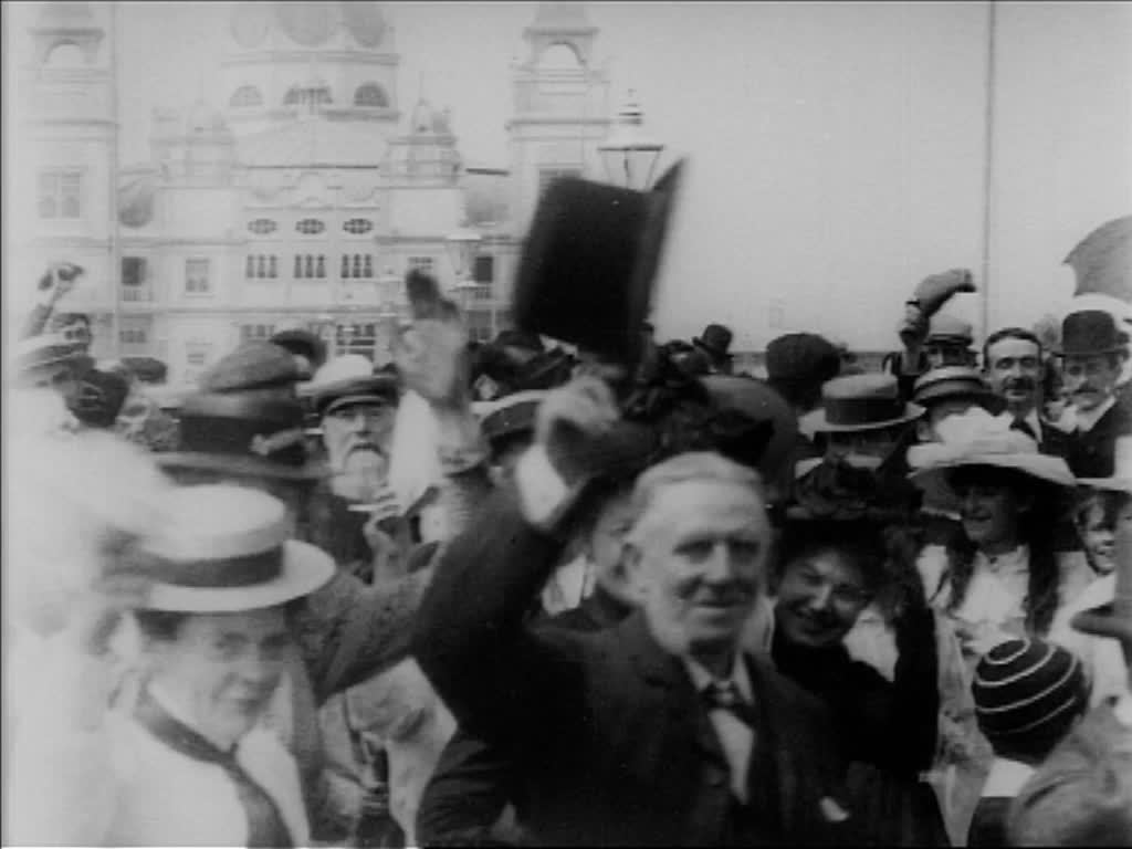 A formal parade gives way to jollity on the pier in Edwardian Morecambe.