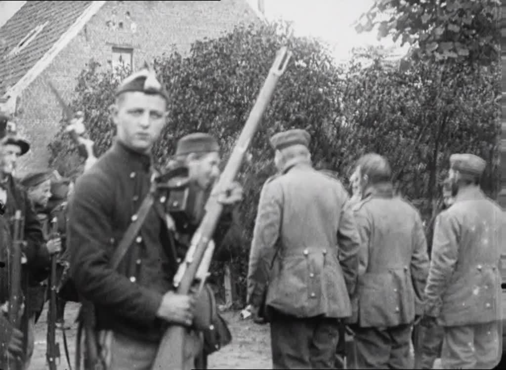 Striking WWI scenes demonstrating a wary Belgian army's treatment of German prisoners - and newsreel cameramen...