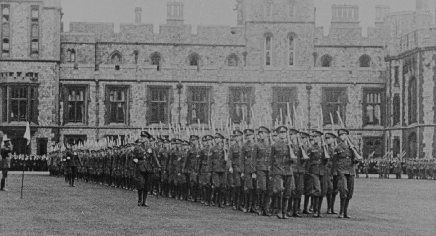 In the grounds of Windsor Castle, George V presents new colours to the Eton College Officers' Training Corps.